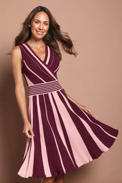 Model Madeline wearing size S of The Reversible Knit Dress in colour Plumstripe (Purple), from the front, cropped image