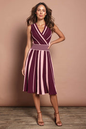 Model Madeline wearing size S of The Reversible Knit Dress in colour Plumstripe (Purple), from the front, showing the whole outfit