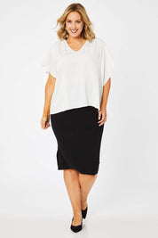 Model Jess wearing size L of The Ribbed Knit Skirt in colour Black (Black), from the front, showing the whole outfit