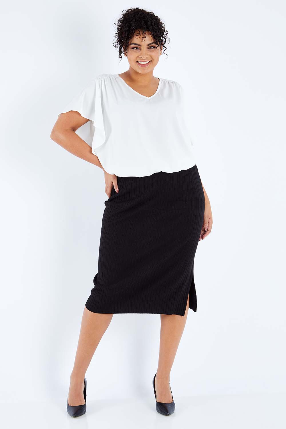 Model Sasha-Lee wearing size XL of The Ribbed Knit Skirt in colour Black (Black), from the front, showing the whole outfit