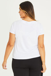Model Palatina wearing size 16 of The Asymmetrical Neckline Top in colour White (White), from the back