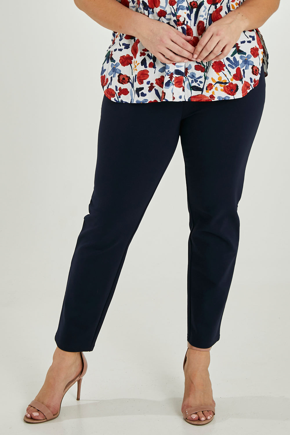 Model Maddy wearing size 16 of The High Rise Pull On Ponte Pant in colour Navy (Blue), from the front, cropped image