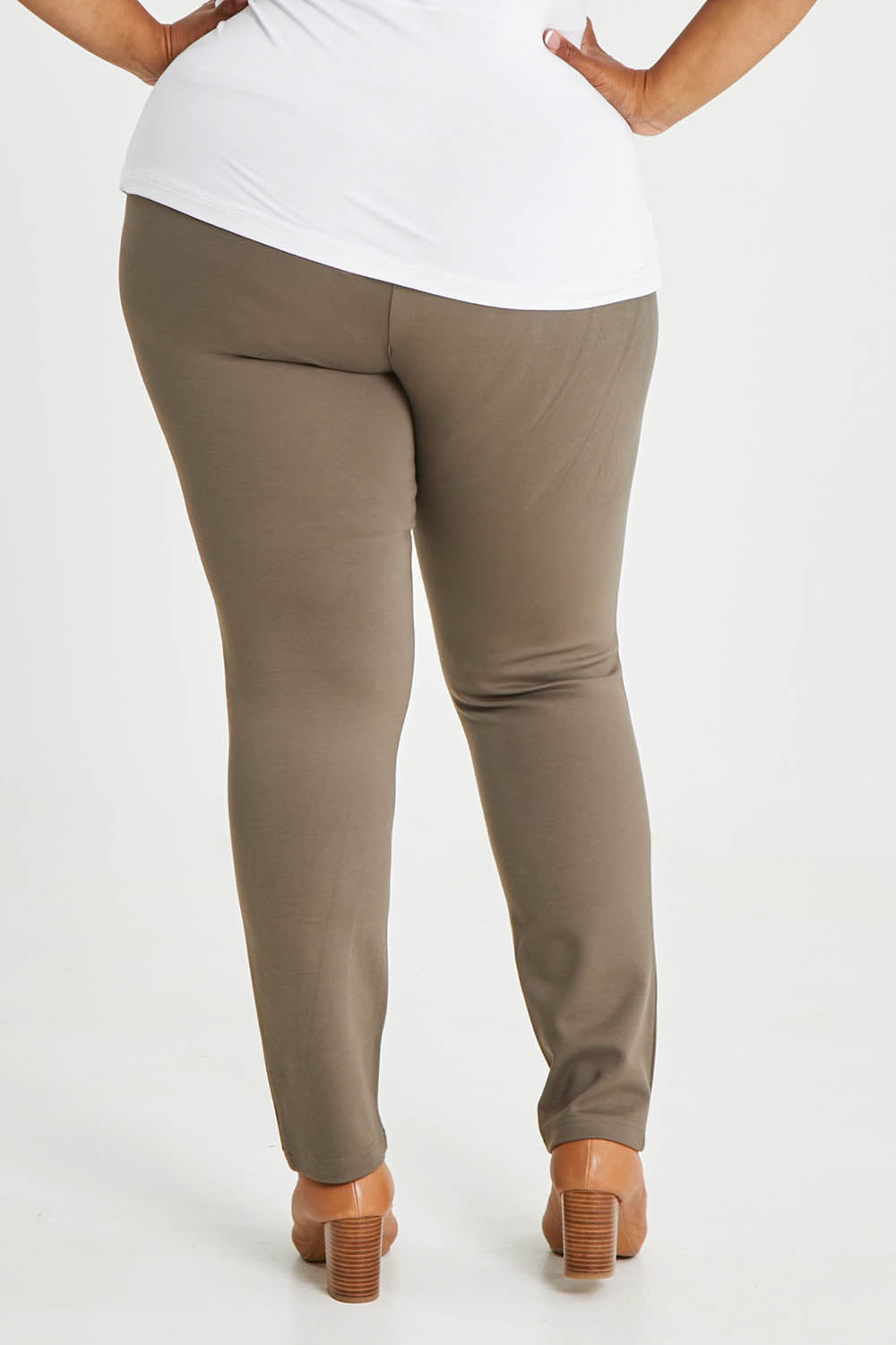 Model Alexis wearing size 16 of The High Rise Pull On Ponte Pant in colour Taupe, from the back