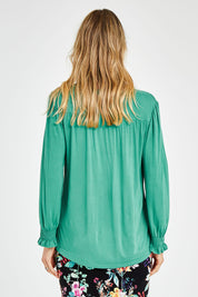 Model Kelly wearing size 10 of The Modal Top in colour Jade (Green), from the back