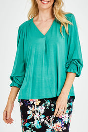 Model Kelly wearing size 10 of The Modal Top in colour Jade (Green), from the front, cropped image