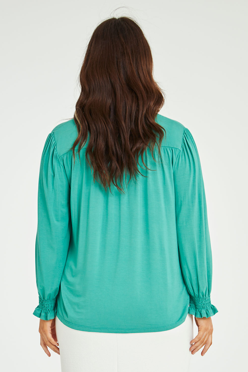 Model Laura wearing size 14 of The Modal Top in colour Jade (Green), from the back