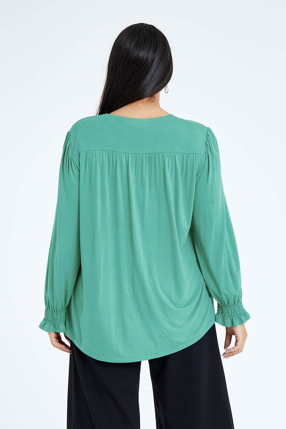 Model Olivia wearing size 16 of The Modal Top in colour Jade (Green), from the back