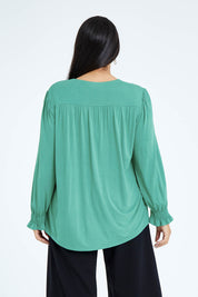 Model Olivia wearing size 16 of The Modal Top in colour Jade (Green), from the back