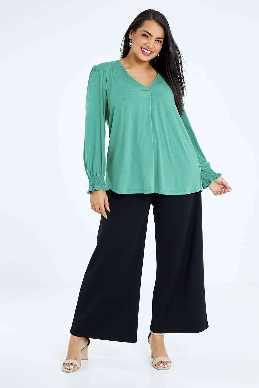 Model Sasha-Lee wearing size 16 of The Modal Top in colour Jade (Green), from the front, showing the whole outfit