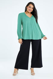 Model Sasha-Lee wearing size 16 of The Modal Top in colour Jade (Green), from the front, showing the whole outfit