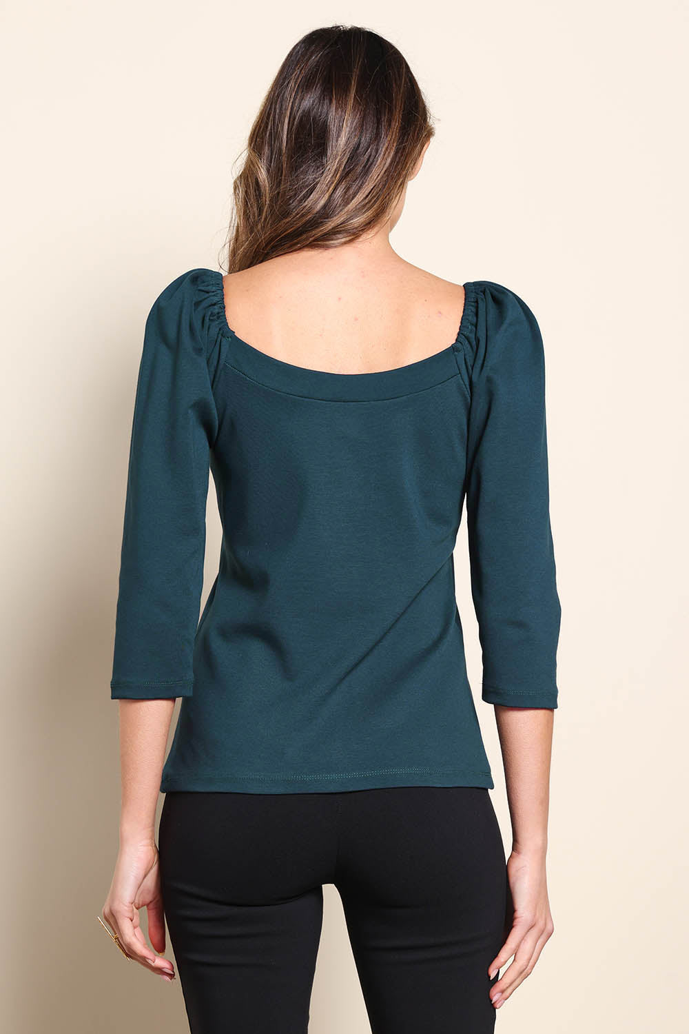 Model Madelinec wearing size 10 of the The Define Ponte Top – Lagoon in colour Lagoon, from the back