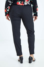 Model Sasha-Lee wearing size 16 of The Stretch Tapered Pull On Pant in colour Black (Black), from the back