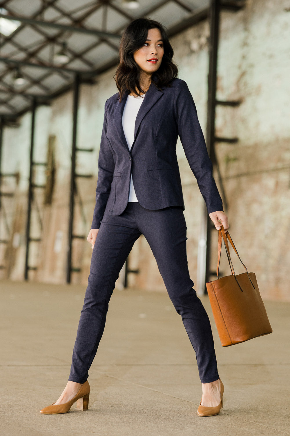 Model Miranda wearing The Stretch Tapered Pull On Pant in colour Navy (Blue), from the front, showing the whole outfit