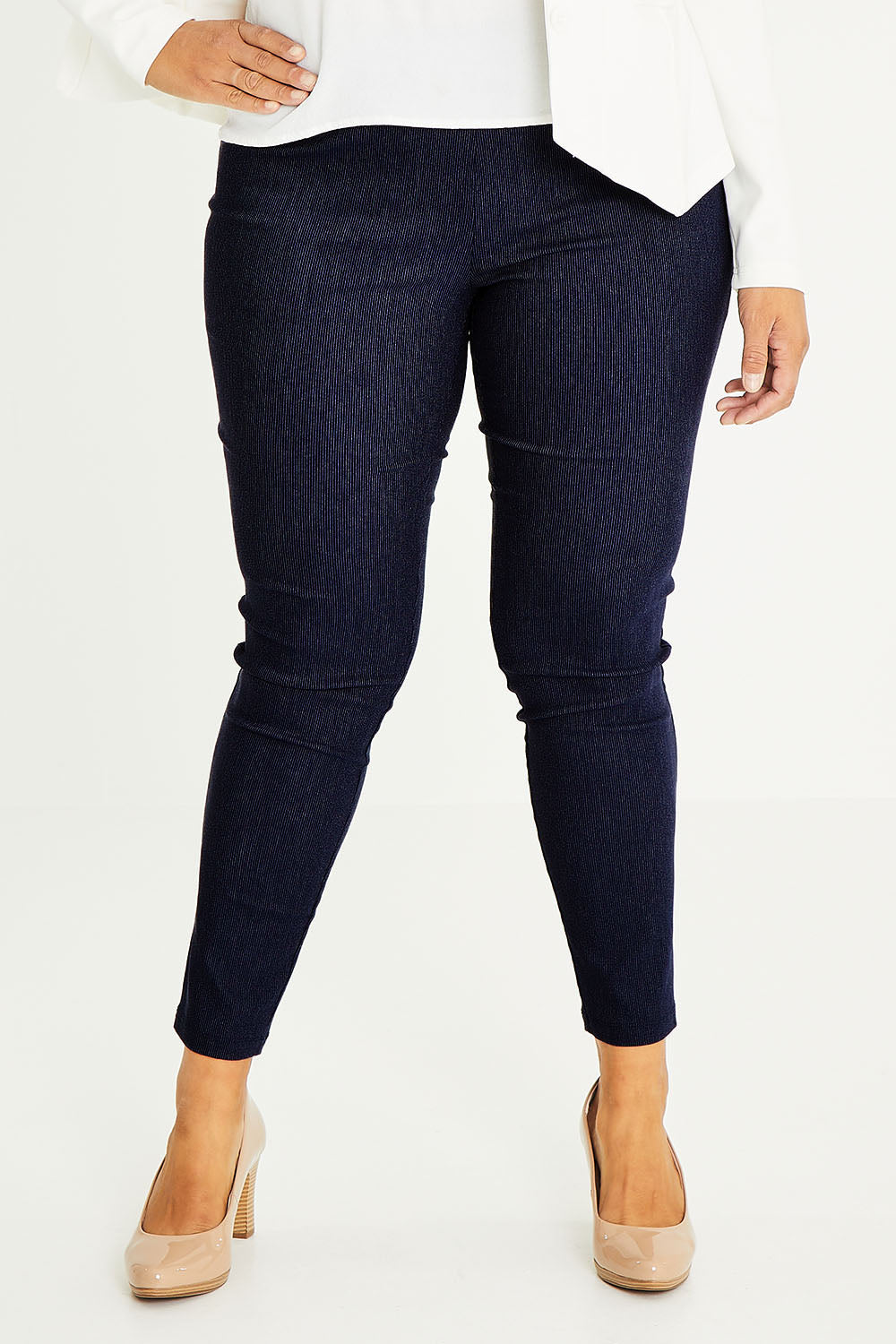 Model Palatina wearing size 16 of The Stretch Tapered Pull On Pant in colour Navy (Blue), from the front, cropped image