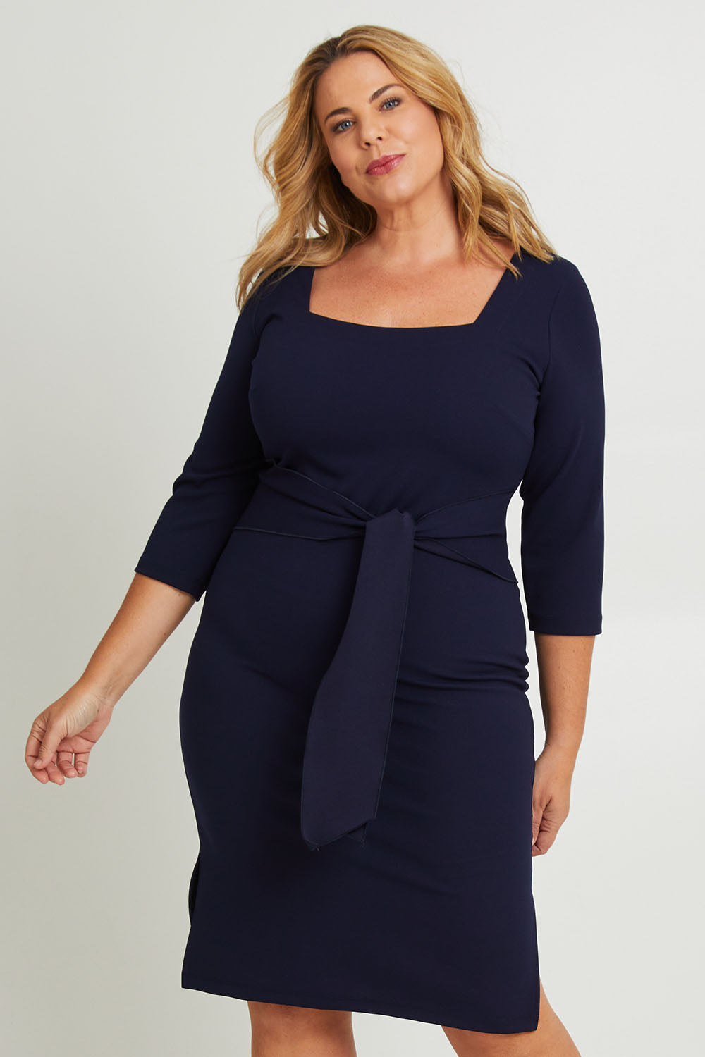 Model Fiona wearing size 16 of The Square Neck Tapered Dress in colour Navy (Blue), from the front, cropped image