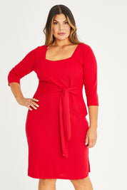 Model Palatina wearing size 16 of The Square Neck Tapered Dress in colour Red (Red), from the front, cropped image