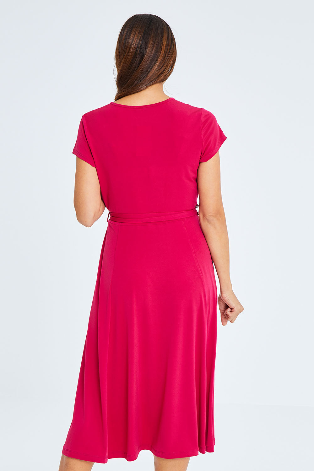 Model Cara wearing size 10 of The Fit And Flare Jersey Dress in colour Cerise (Pink), from the back