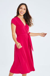 Model Cara wearing size 10 of The Fit And Flare Jersey Dress in colour Cerise (Pink), from the front, cropped image