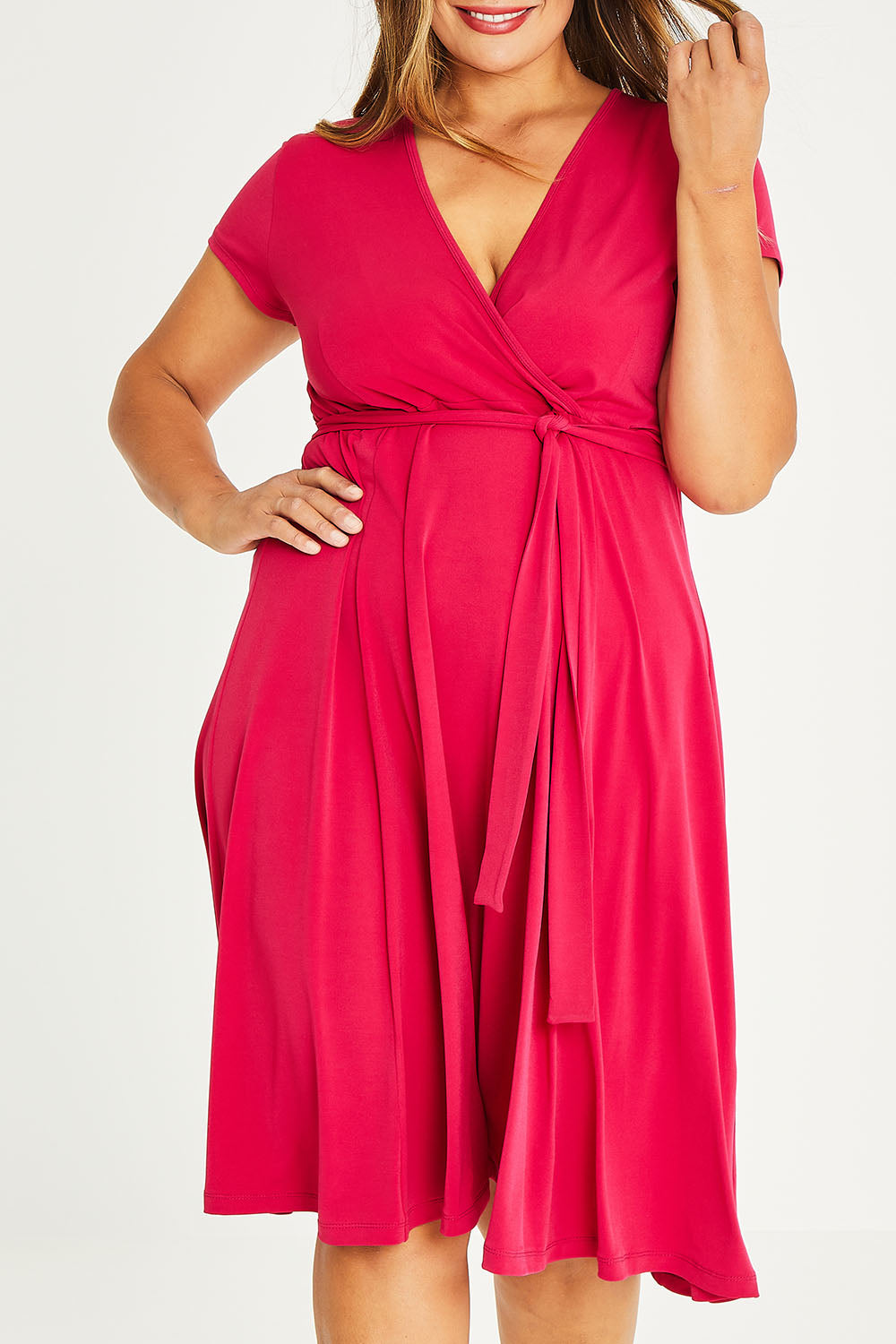 Model Palatina wearing size 16 of The Fit And Flare Jersey Dress in colour Cerise (Pink), from the front, cropped image