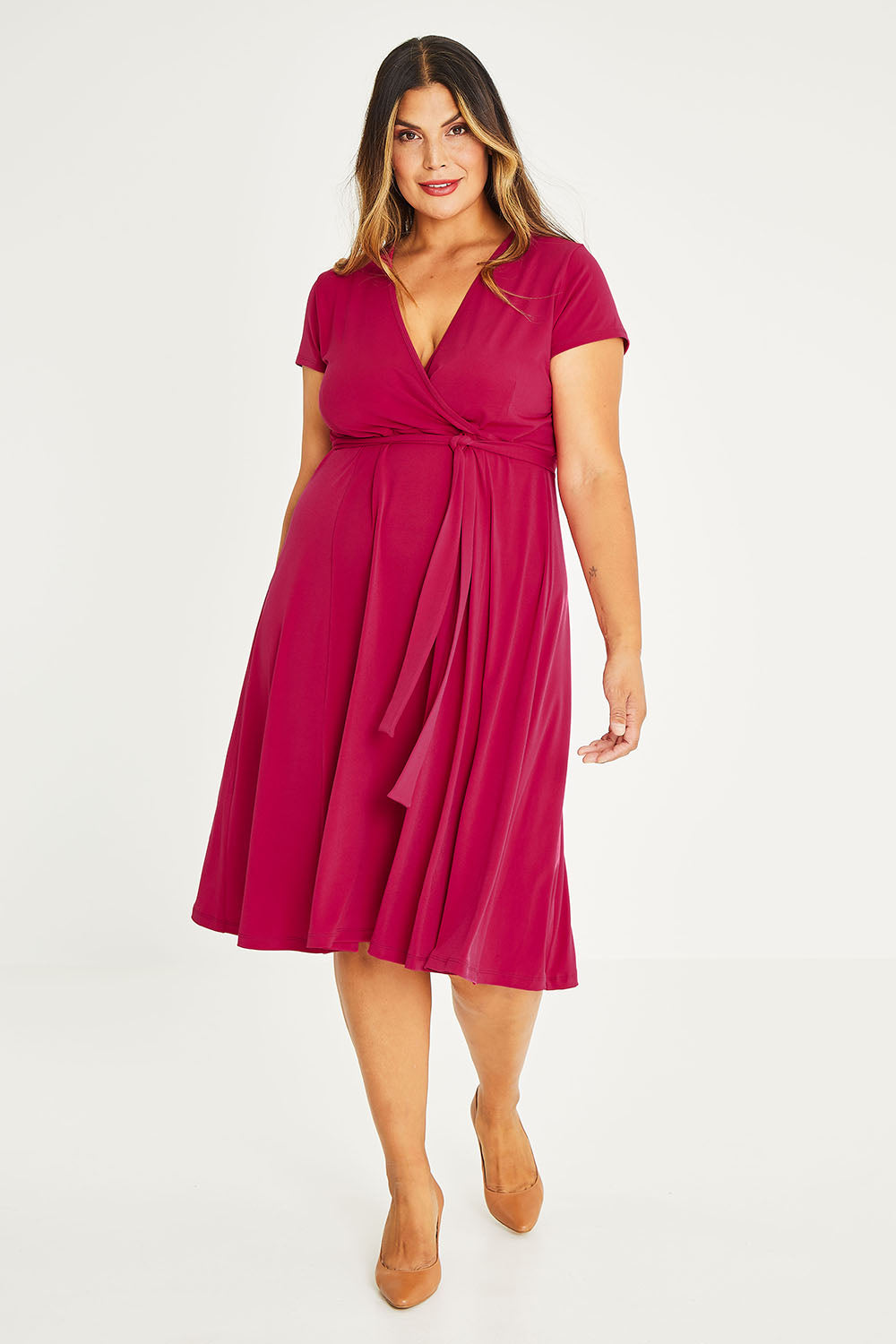 Model Palatina wearing size 16 of The Fit And Flare Jersey Dress in colour Cerise (Pink), from the front, showing the whole outfit