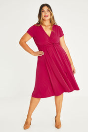 Model Palatina wearing size 16 of The Fit And Flare Jersey Dress in colour Cerise (Pink), from the front, showing the whole outfit