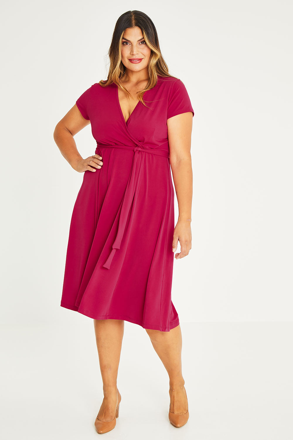 Model Palatina wearing size 16 of The Fit And Flare Jersey Dress in colour Cerise (Pink), from the front, showing the whole outfit