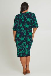 Model Ashleigh wearing size 16 of The Printed Knot Waist Detail Dress in colour Greenfleur (Green), from the back