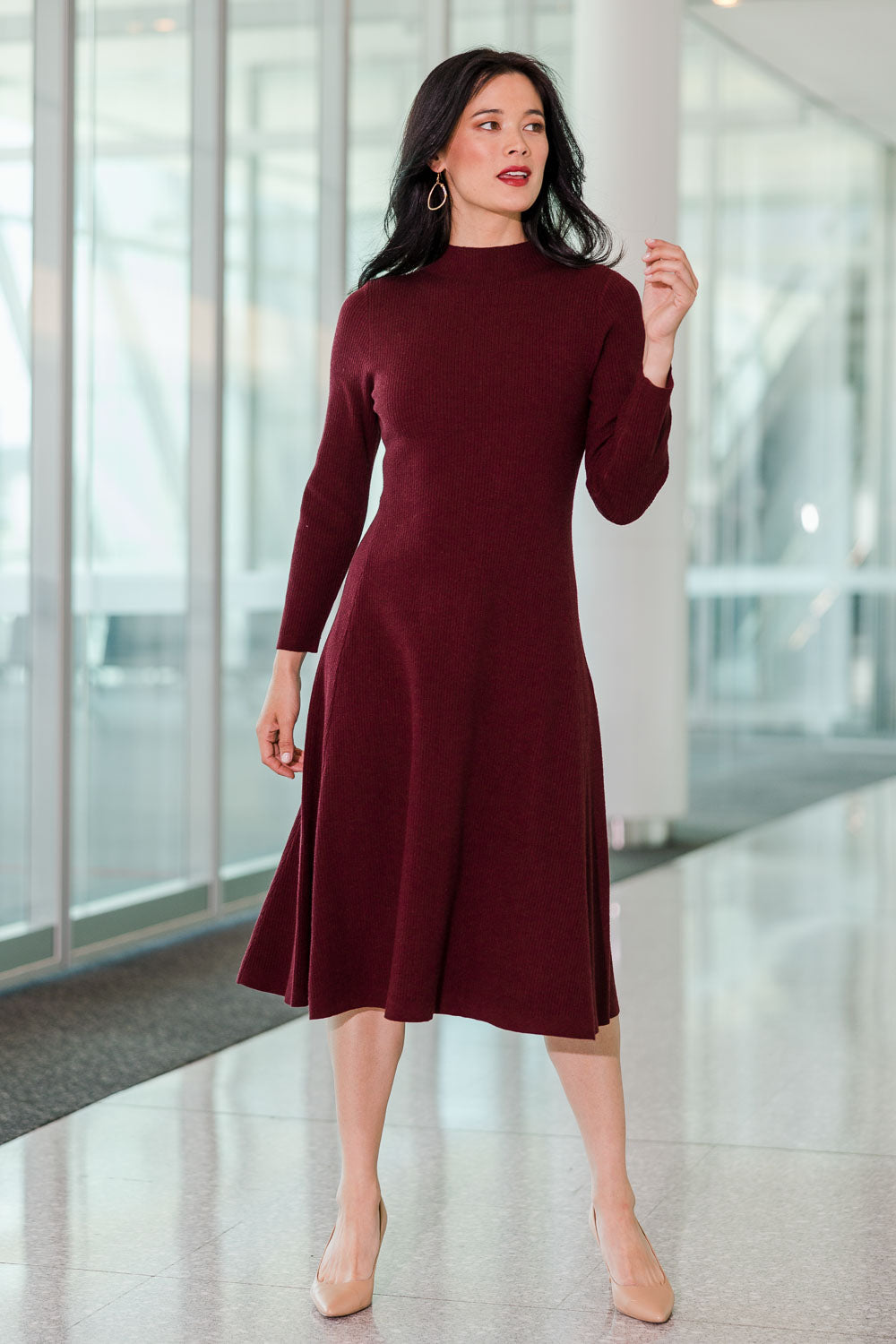 Model Miranda wearing size S of The Fit And Flare Knitted Rib Dress in colour Burgundy (Red), from the front, showing the whole outfit