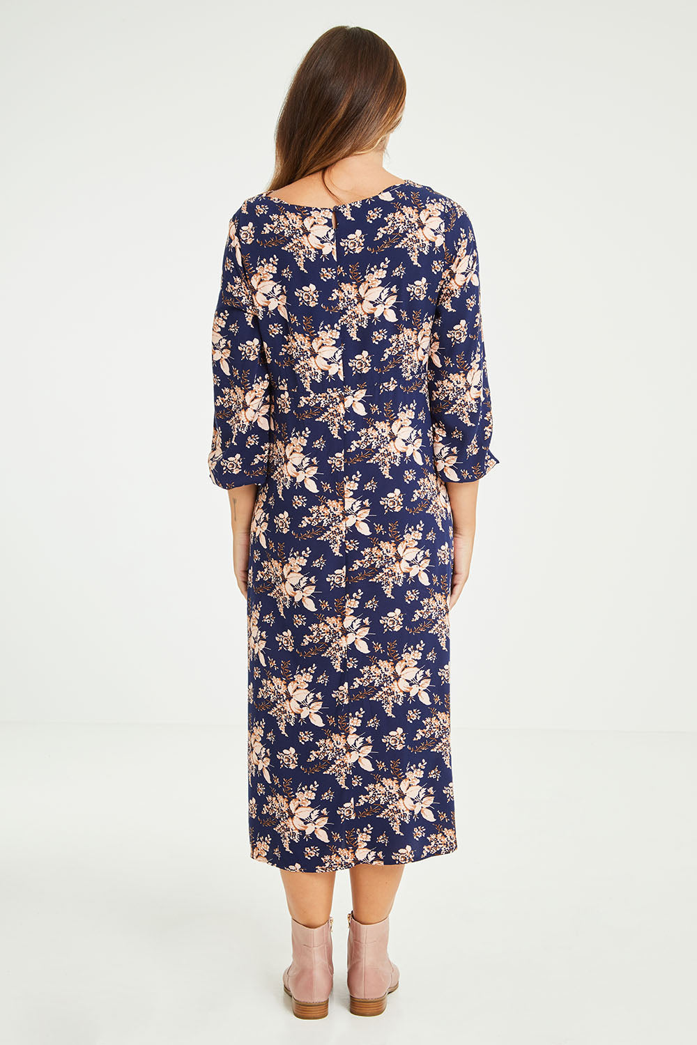 Model Tahlia wearing size 10 of The Printed Rayon Dress in colour Floral (Blue), from the back