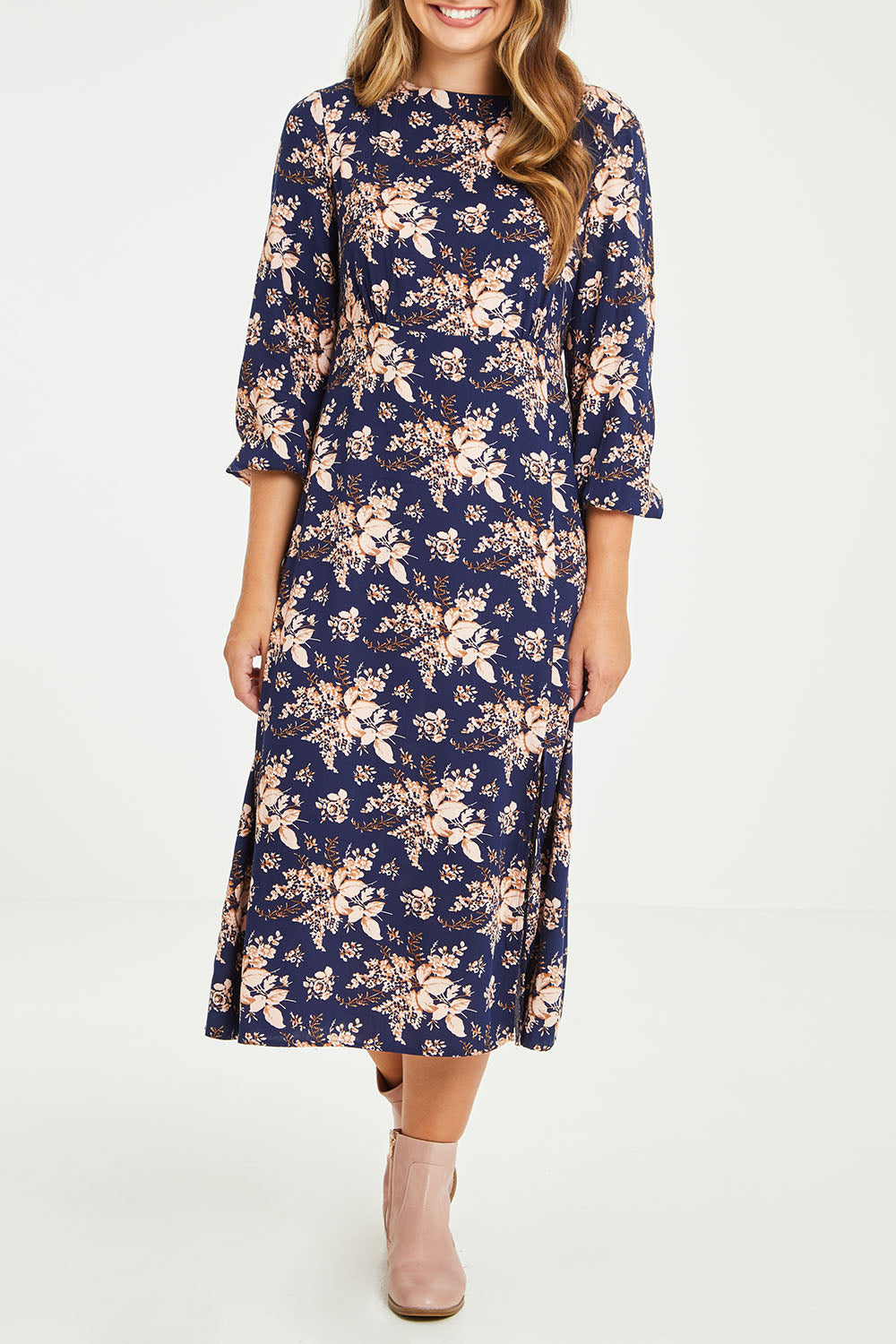 Model Tahlia wearing size 10 of The Printed Rayon Dress in colour Floral (Blue), from the front, cropped image