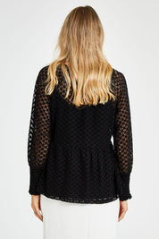 Model Kelly wearing size 10 of The Smocked Cuff Lace Blouse in colour Black (Black), from the back