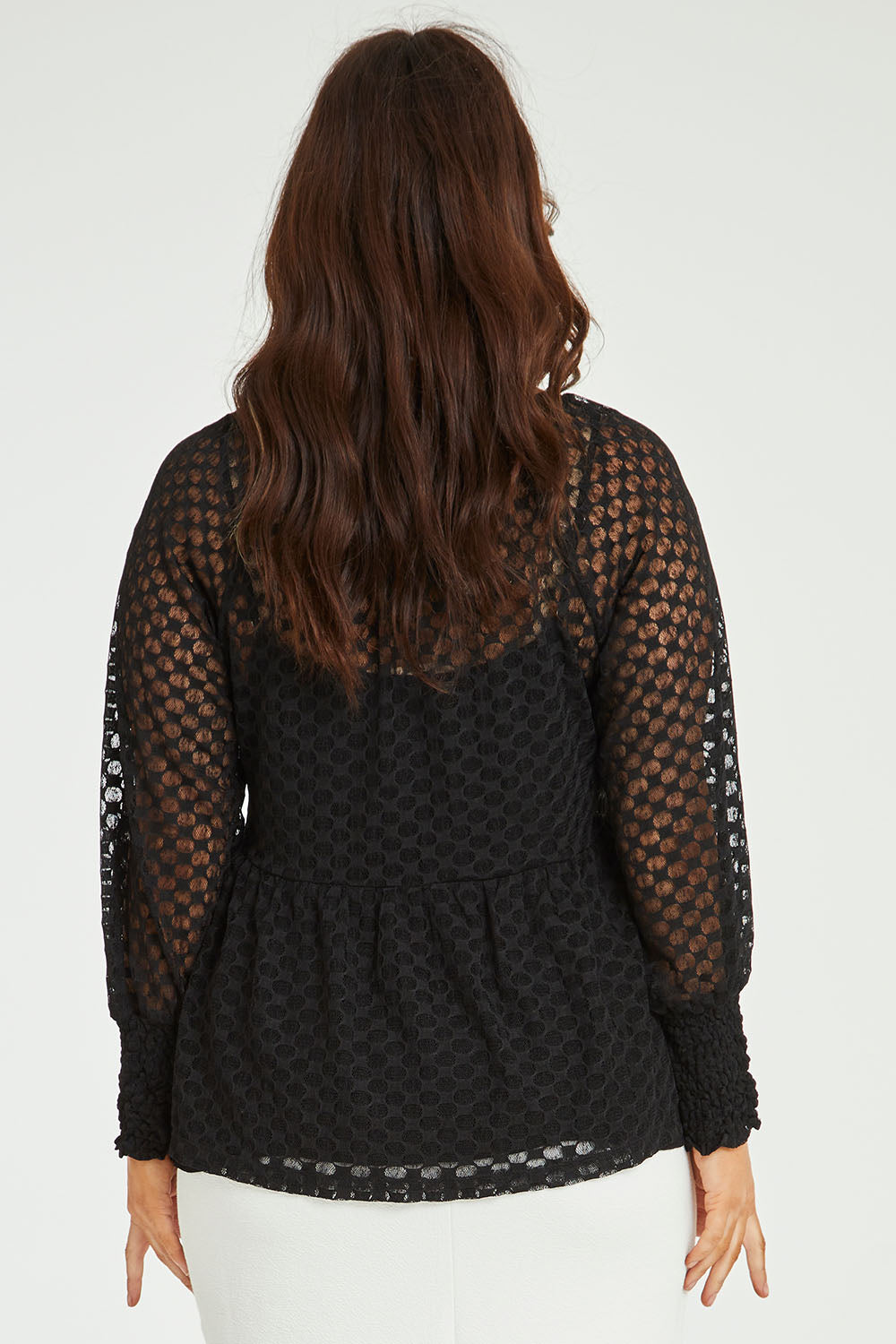 Model Laura wearing size 14 of The Smocked Cuff Lace Blouse in colour Black (Black), from the back
