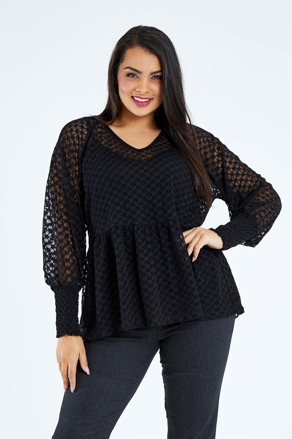 Model Sasha-Lee wearing size 16 of The Smocked Cuff Lace Blouse in colour Black (Black), from the front, cropped image