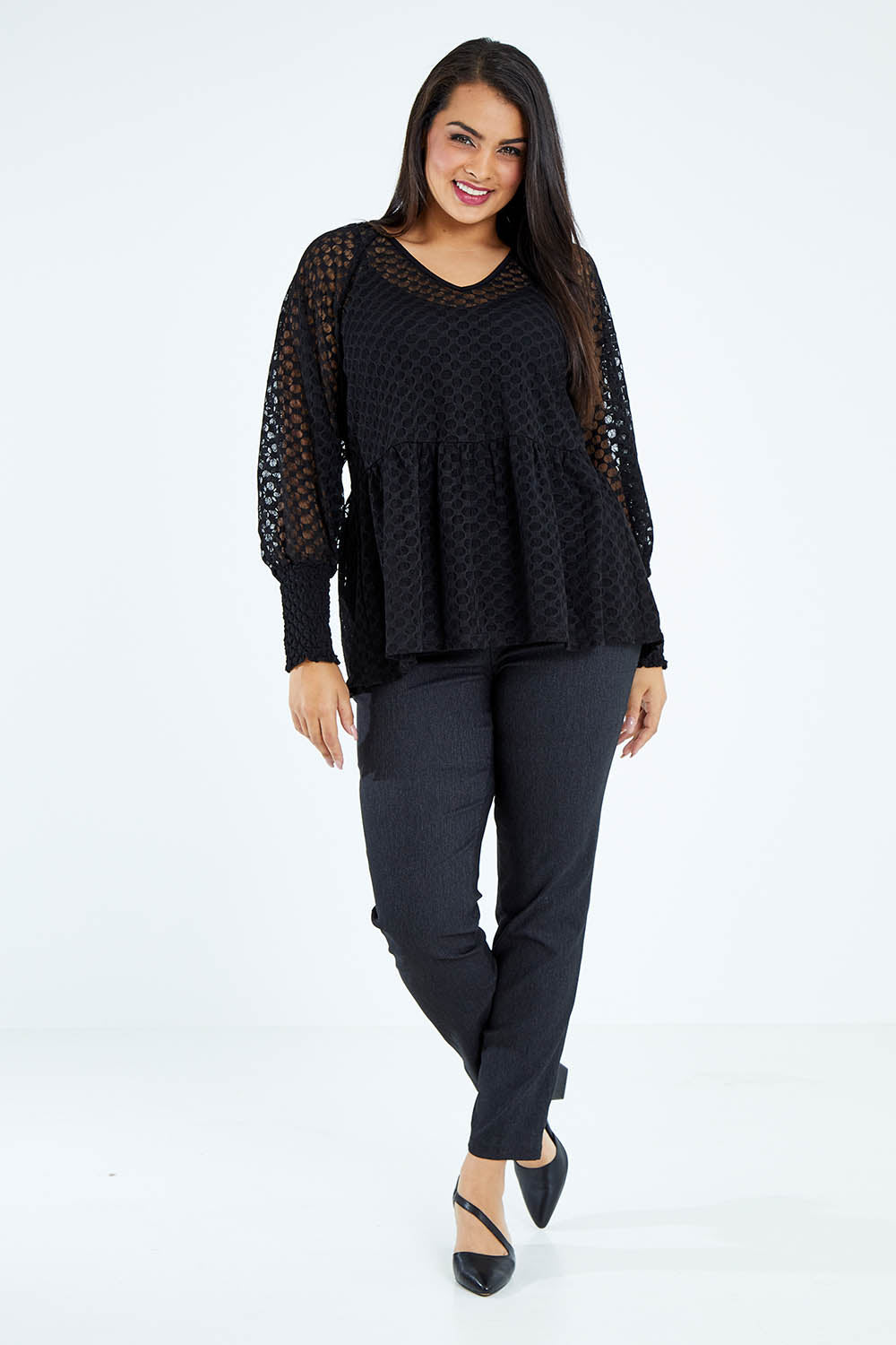Model Sasha-Lee wearing size 16 of The Smocked Cuff Lace Blouse in colour Black (Black), from the front, showing the whole outfit