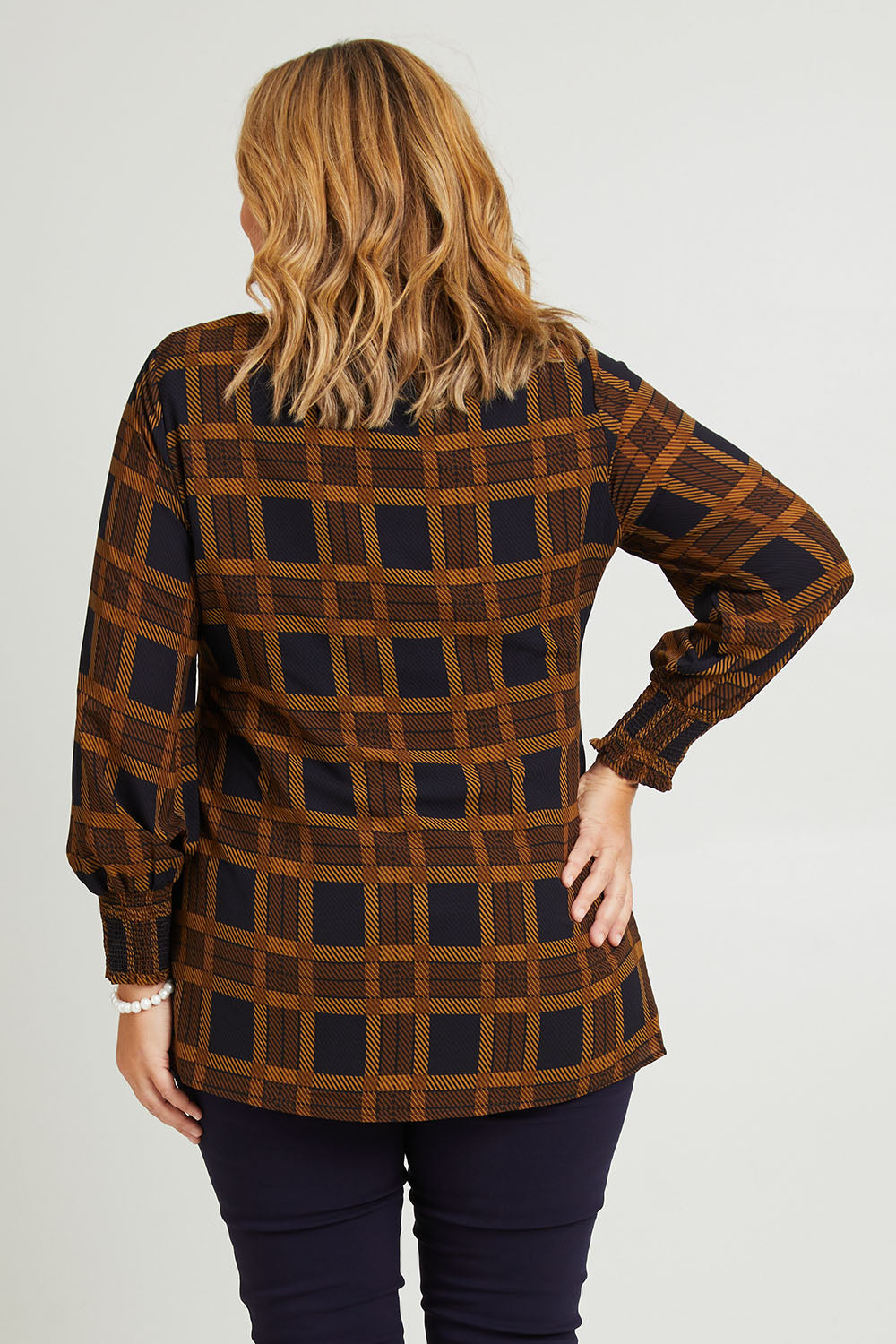 Model Fiona wearing size 16 of The Printed Chiffon Lined Tunic in colour Checks (Blue), from the back