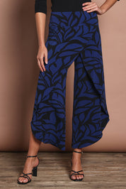 Model Madeline wearing size 10 of The Printed Cross Over Pant in colour Bluevines (Blue), from the front, cropped image