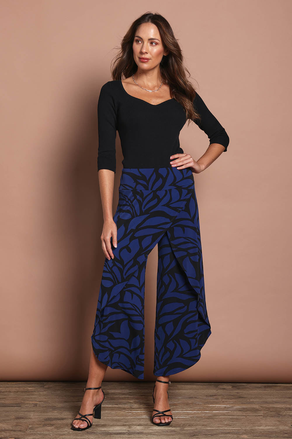 Model Madeline wearing size 10 of The Printed Cross Over Pant in colour Bluevines (Blue), from the front, showing the whole outfit
