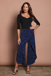 Model Madeline wearing size 10 of The Printed Cross Over Pant in colour Bluevines (Blue), from the front, showing the whole outfit