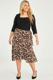 Model Katie wearing size 16 of The Lined Faux Wrap Ruffle Skirt in colour Vines, from the front, showing the whole outfit