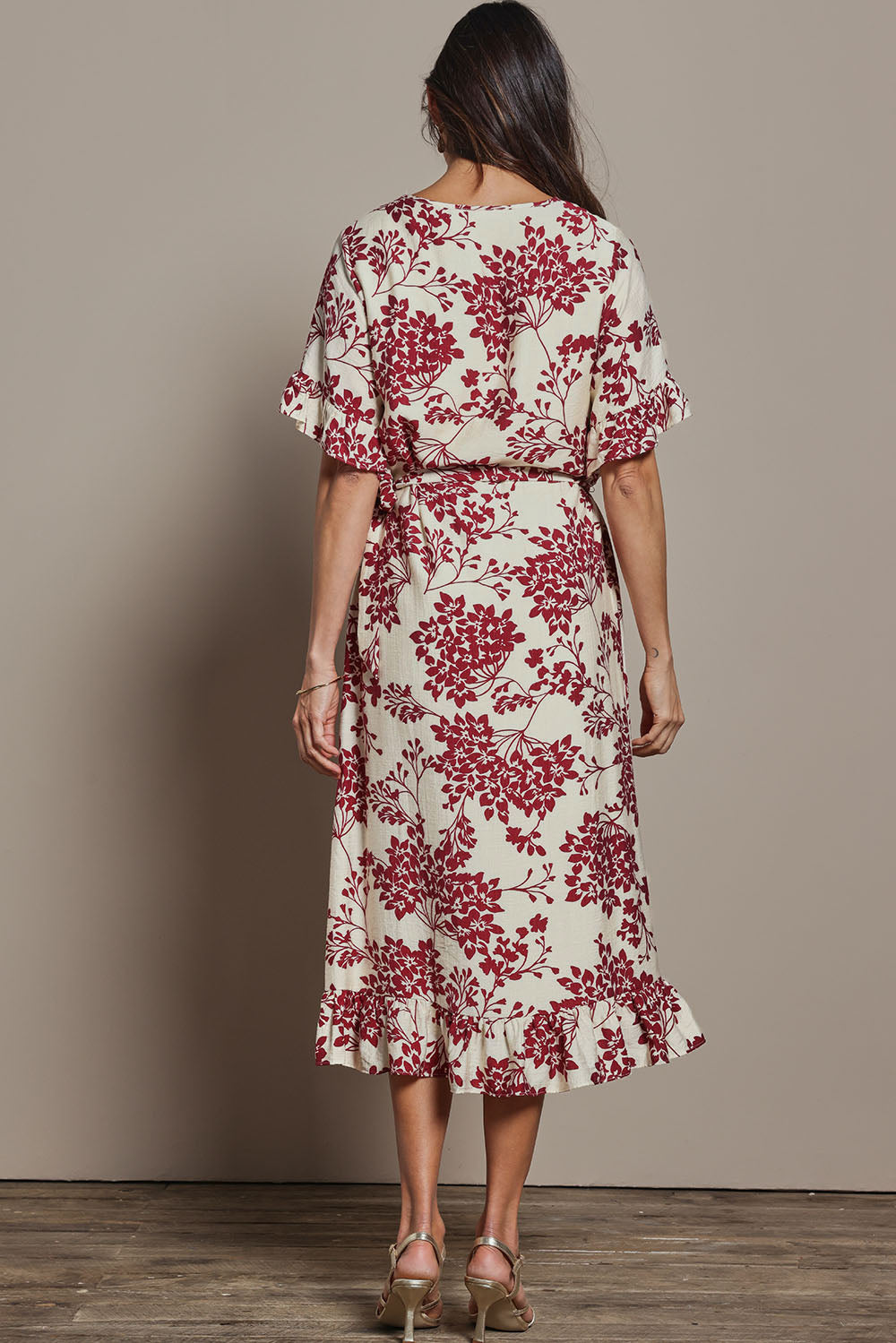 Model Amanda wearing size 10 of The Lined Kimono Sleeve Ruffle Hem Dress in colour Winebloom (Red), from the back