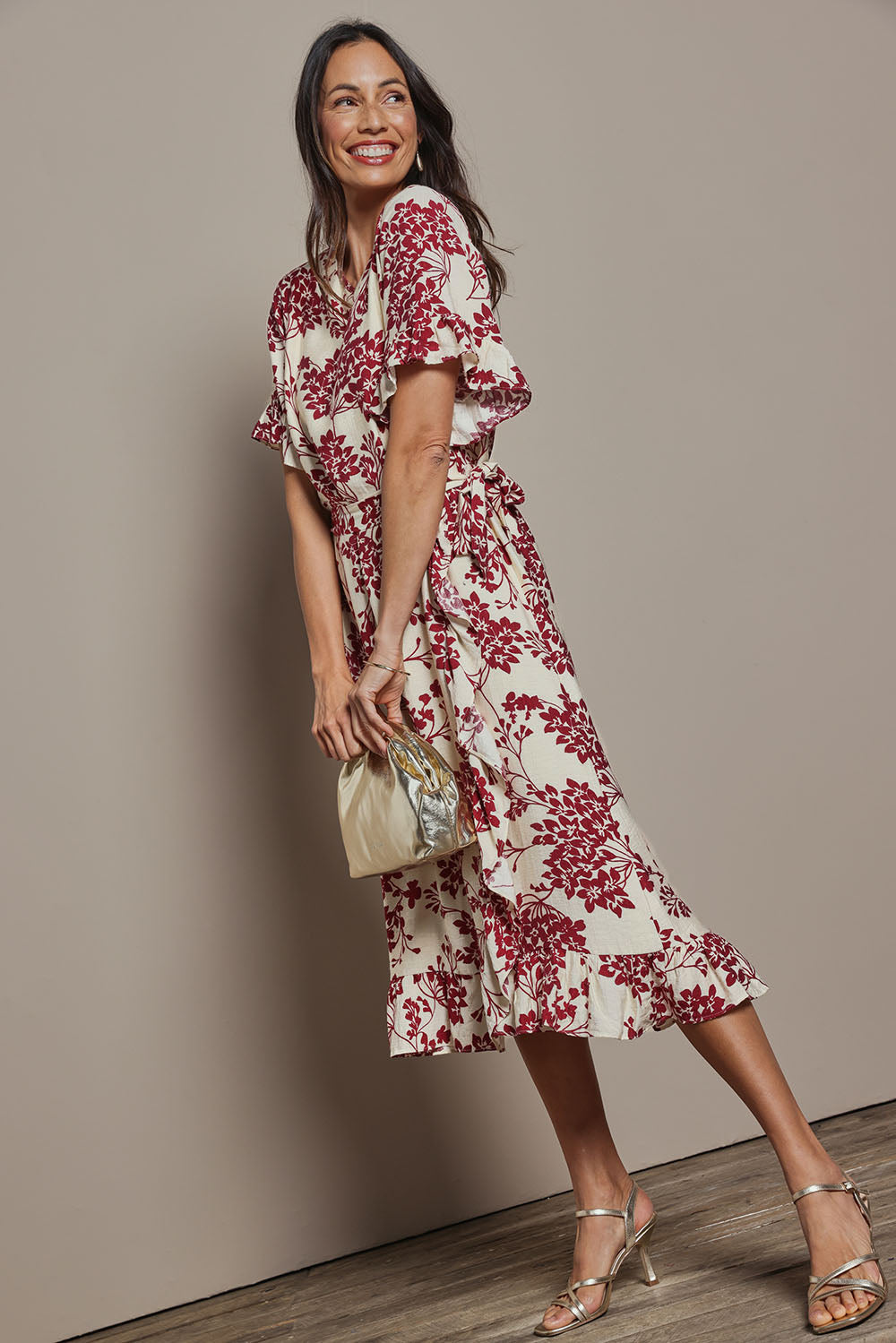 Model Amanda wearing size 10 of The Lined Kimono Sleeve Ruffle Hem Dress in colour Winebloom (Red), from the front, showing the whole outfit