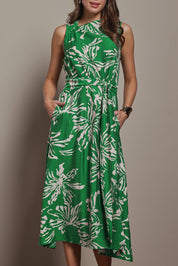 Model Madeline wearing size 10 of The Printed Adore Dress in colour Greenfleur (Green), from the front, cropped image