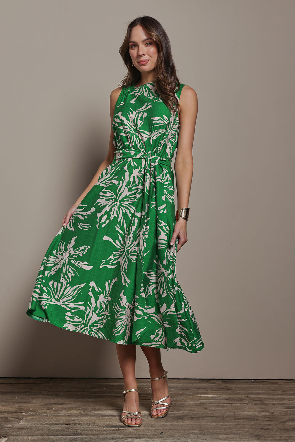 Model Madeline wearing size 10 of The Printed Adore Dress in colour Greenfleur (Green), from the front, showing the whole outfit