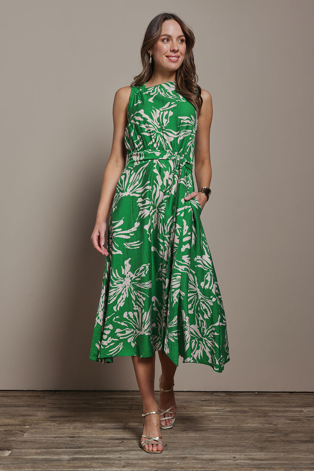 Model Madeline wearing size 10 of The Printed Adore Dress in colour Greenfleur (Green), from the front, showing the whole outfit