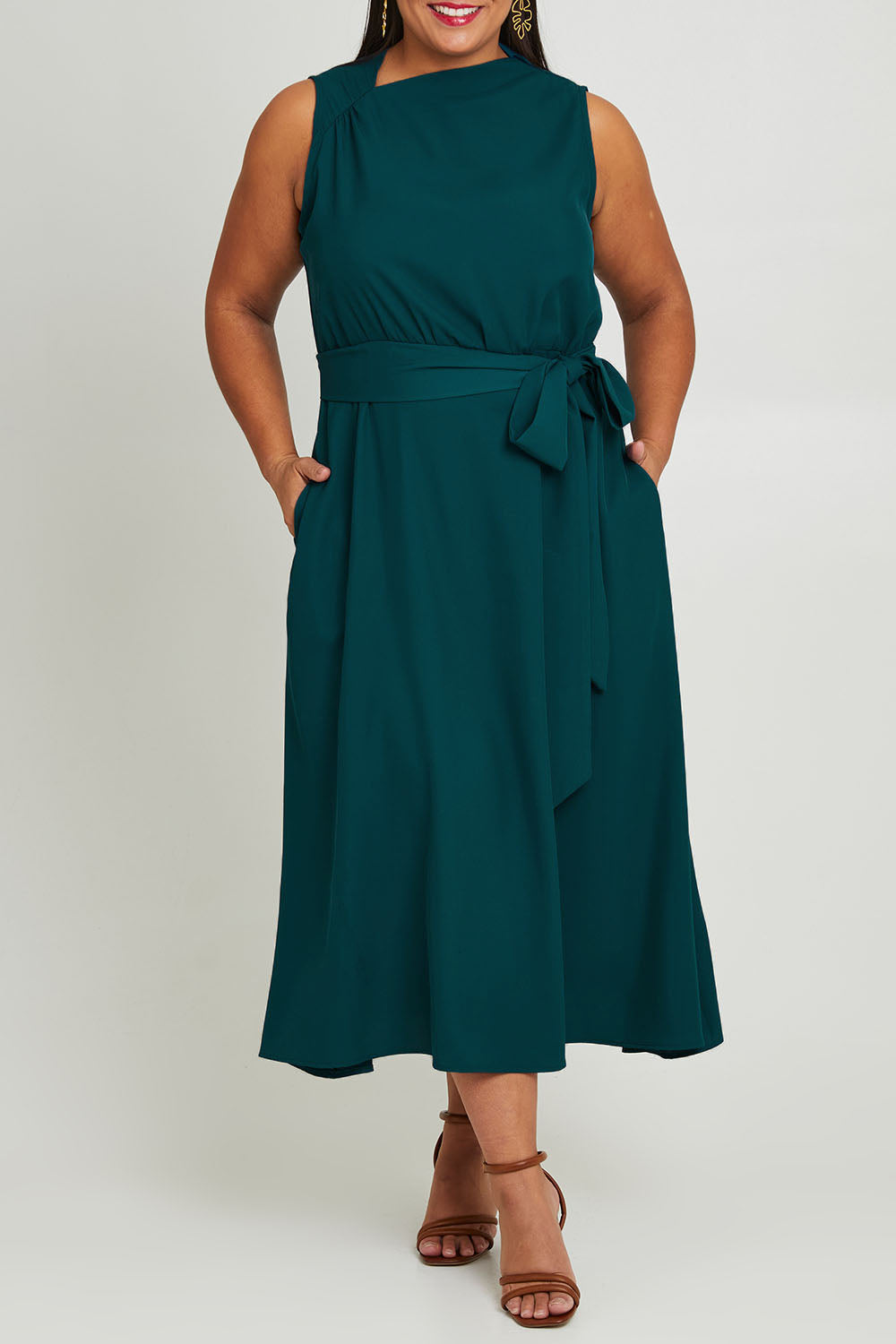 Model Ashleigh wearing size 16 of The Adore Dress in colour Jewel (Green), from the front, cropped image