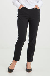 Model Katie wearing size 10 of The 7/8 Pocket Pull On Pant in colour Black (Black), from the front, cropped image