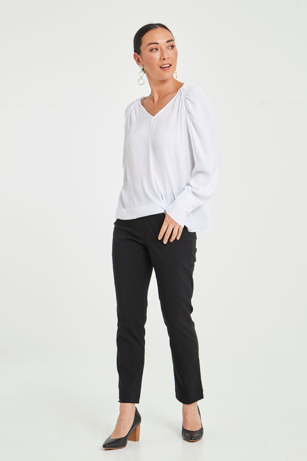Model Katie wearing size 10 of The 7/8 Pocket Pull On Pant in colour Black (Black), from the front, showing the whole outfit