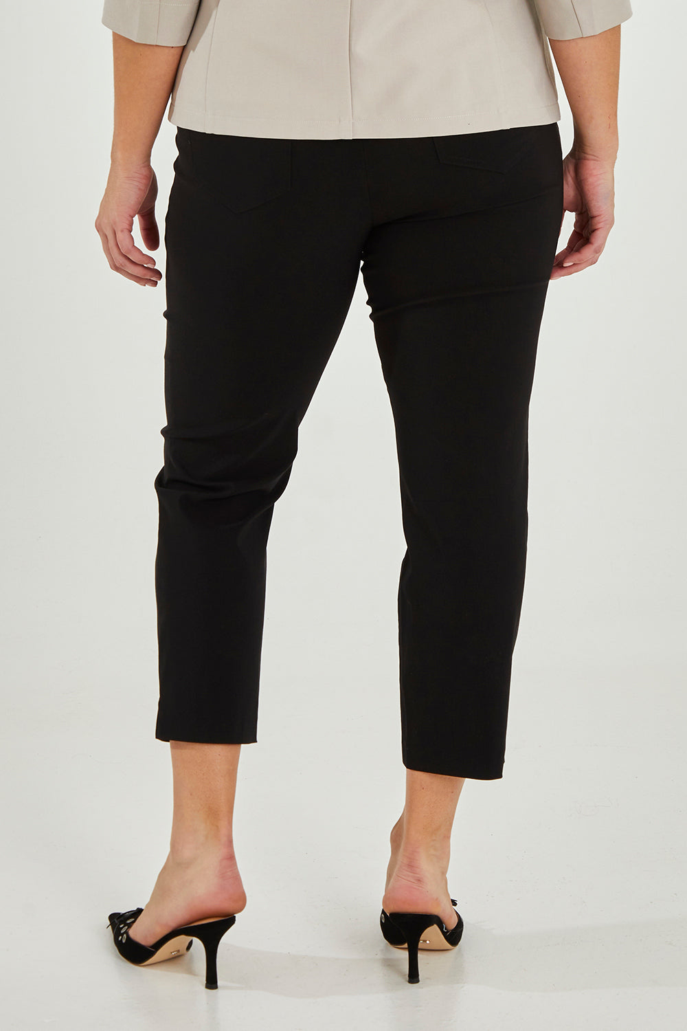 Model Maddy wearing size 16 of The 7/8 Pocket Pull On Pant in colour Black (Black), from the back