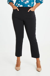 Model Noli wearing size 14 of The 7/8 Pocket Pull On Pant in colour Black (Black), from the front, cropped image