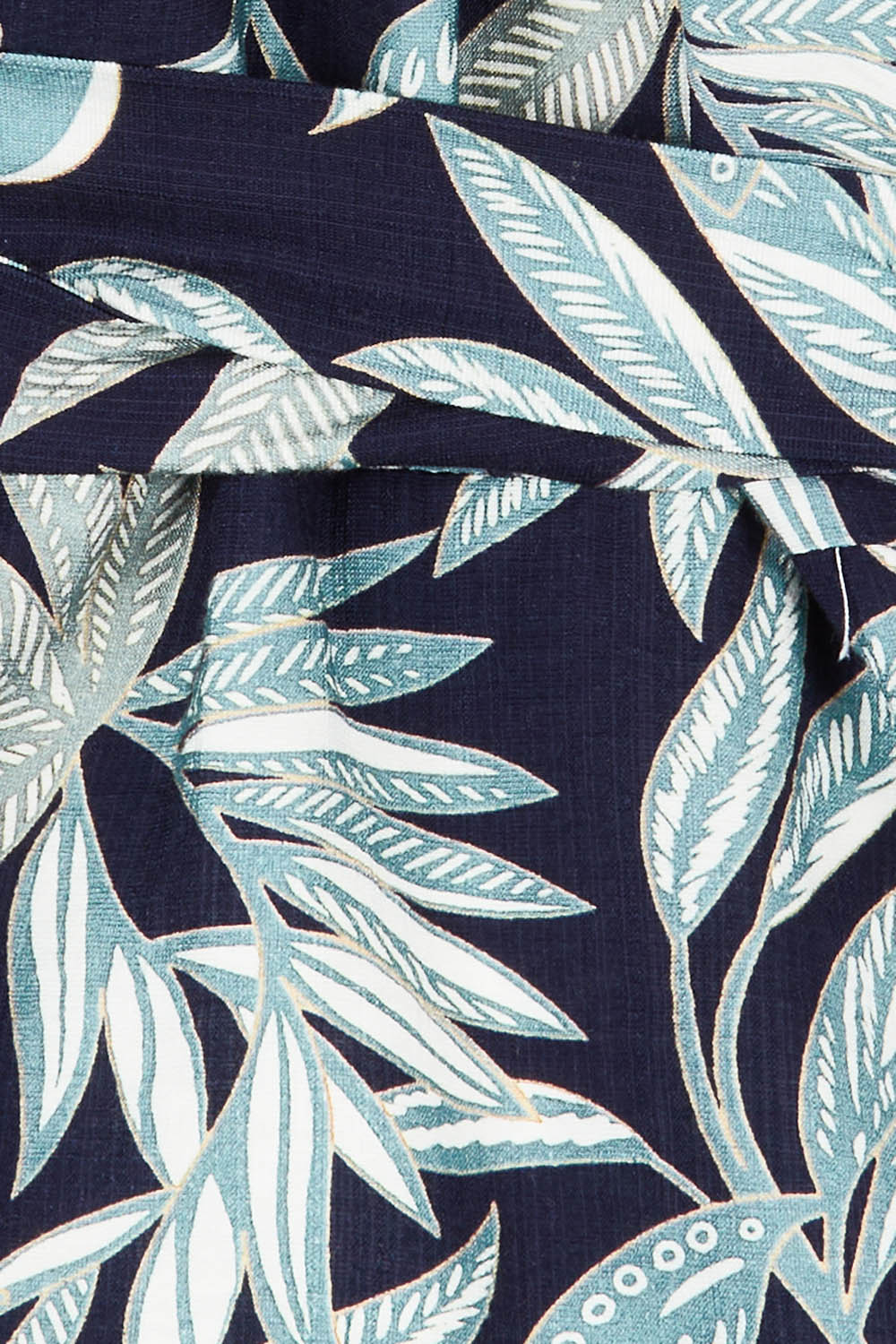 Product shot of The Printed Blouson Sleeve Wrap Blouse in colour Navyleaf (Blue), detail